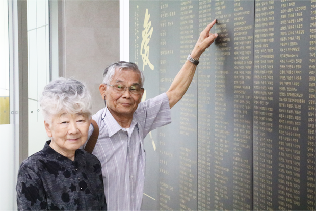 어린이재활병원 기부벽 앞에서 기념사진을 찍고 있는 노무라 할아버지와 요리코 할머니