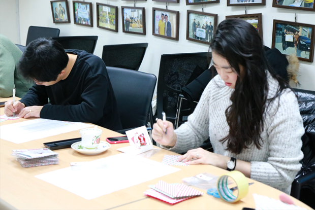 장애어린이와 가족들에게 손 편지를 쓰고 있는 현대모비스 임직원들
